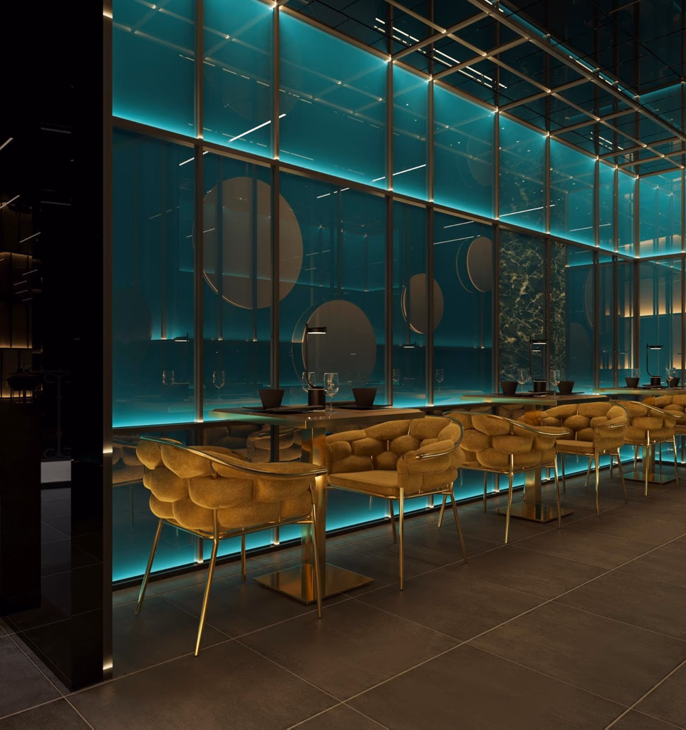 Modern restaurant interior with teal illuminated walls, circular wall art, and plush mustard-yellow chairs around square tables.
